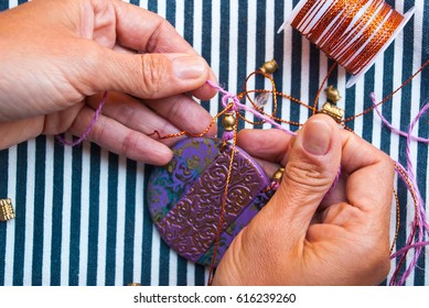 Woman hand making pendant polymer clay  Hobby  handicraft background  Working process  Trend jewelry Work and rope 