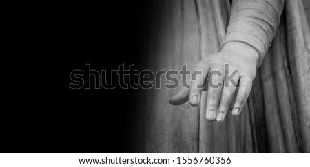 Woman hand on antique tunic. Stone statue detail of human hand. Folds in the fabric. Copyspace for text