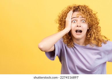 Woman with hand on head expressing dismay