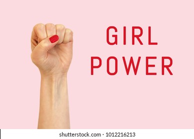 A woman hand on a pink background and inscription Girl power - Shutterstock ID 1012216213
