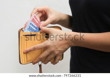 woman hand open wallet and showing rupiah money