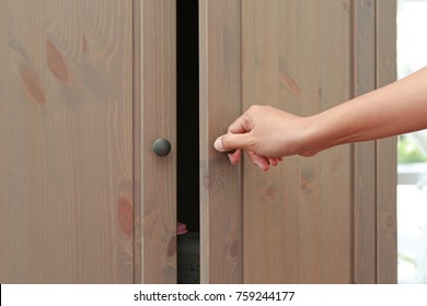 Woman Hand Opening Cabinet Doors.