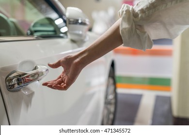 Woman Hand Opening Car Door Inside A Parking.