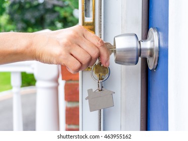 Woman Hand Opening A Door With Keys