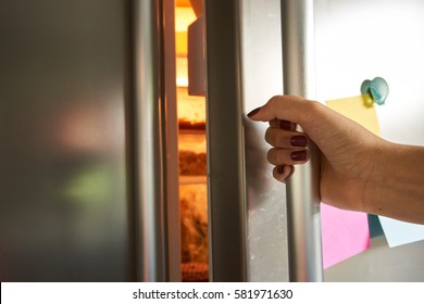 Woman Hand Opens Refrigerator Door