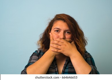 Woman With Hand Over Her Mouth