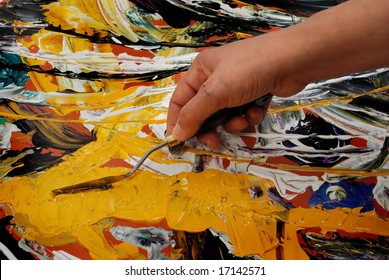 Woman Hand Painting In Yellow  With Spatula