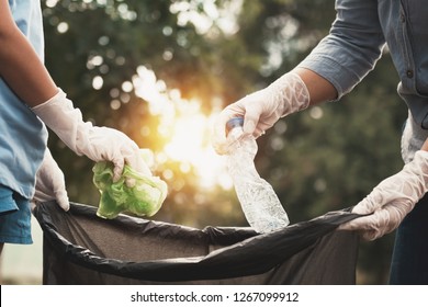 woman hand picking up garbage plastic for cleaning at park