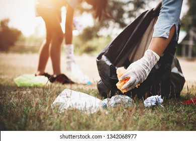 Woman Hand Picking Up Garbage Plastic For Cleaning At Park