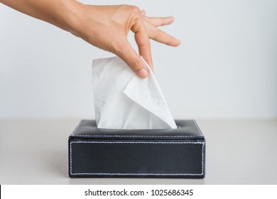 Woman Hand Picking White Tissue Paper From Tissue Box.