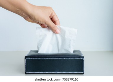 Woman Hand Picking White Tissue Paper From Tissue Box.