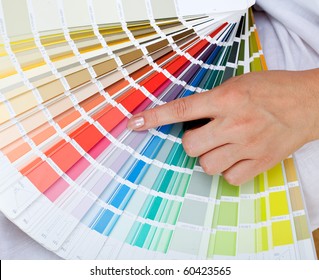 Woman Hand Pointing To A Sample Color Chart