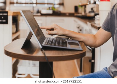 Woman hand pointing the screen of a laptop computer.