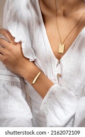 Woman Hand Posing Showing Her Bracelet And Pendant Necklace. Women's Hand With Gold Bracelet. Still Life Photo, Minimalism