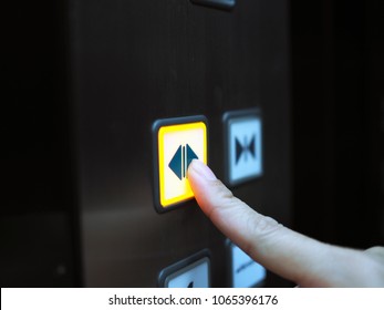 Woman Hand Press Open Button  To Extend Door Inside Elevator.