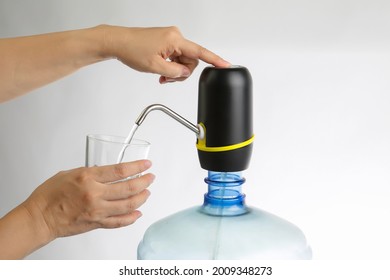woman hand press the water purification filter for drinking water on white background