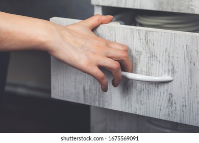Woman hand pulling open wooden drawer in office - Shutterstock ID 1675569091
