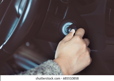 Woman Hand Put Key Into The Ignition And Starts The Car Engine In Vintage Color Tone