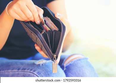 Woman Hand Putting Coins Money Into Wallet