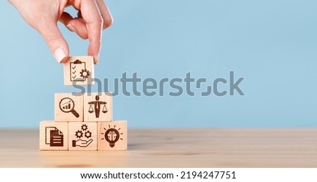 Woman hand putting wooden cubes with ethics icon. Business ethics concept. Business integrity and moral