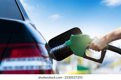 Woman hand refuel the car