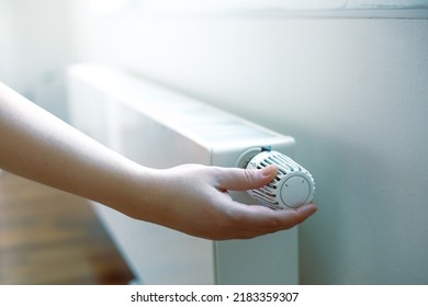 Woman Hand Regulates The Temperature On The Radiator, High Electricity And Gas Prices, Economic Crisis