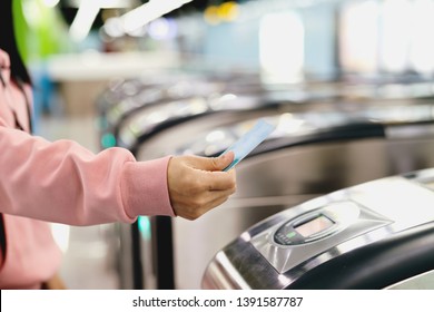 Woman Hand Scanning Train Ticket To Subway Entrance Gate. Transportation Concept