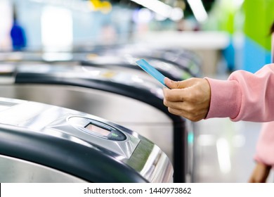 Woman Hand Scanning Train Ticket To Subway Entrance Gate. Transportation Concept