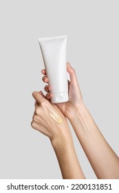 Woman hand showing cream product. Cosmetic product branding mockup. Daily skincare and body care routine. Female hand holding  cosmetic product mockup, close up.  - Shutterstock ID 2200131851