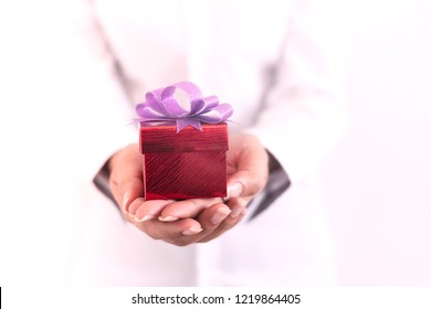 woman hand  showing the gift in a box,holding red Gift box with bow over holiday background which celebrating. - Powered by Shutterstock