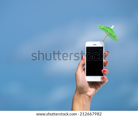 Woman hand showing mobile phone and cocktail umbrella
