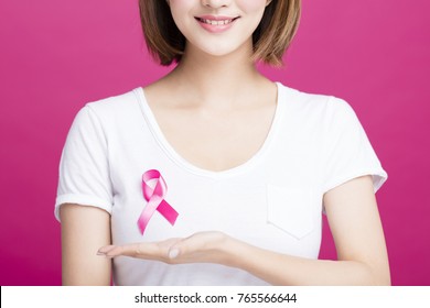 Woman hand showing pink breast cancer awareness ribbon - Powered by Shutterstock