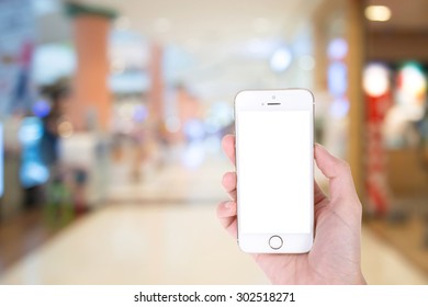 Woman Hand Showing Smart Phone With Isolated Screens Display In A Market Or Department Store