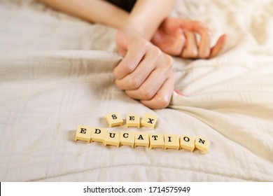 Woman Hand Sign Orgasm On Bed With Scrabble Board Showing Words Sex Education.