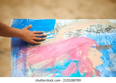 Woman Hand Smearing Blue Paint On Canvas, Art Expression At Outdoor Art Festival. Drip Painting Expression, Smearing And Splattering Paint On White Canvas, Art Improvisation