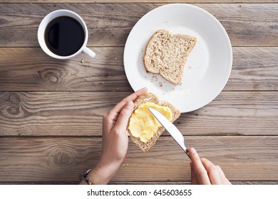 Woman Hand Spreading Butter On Sliced Bread