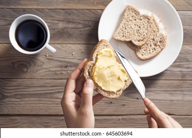 Woman Hand Spreading Butter On Sliced Bread