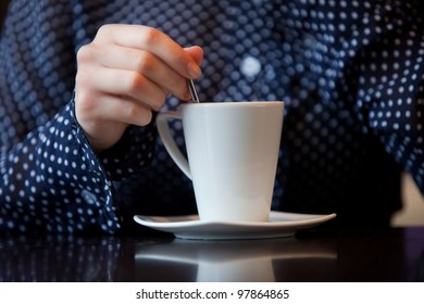 Woman Hand Stir Coffee In White Cup