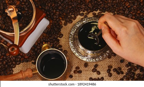 Woman Hand Stirring Coffee In Cup.