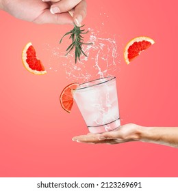 Woman hand support glass of grapefruit drink with splash, juice grapefruit slices falling in glass.