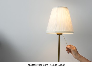 Woman Hand Switch On Table Lamp.