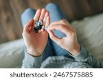 A woman hand take pills from the palm of his hand to take painkillers, medicines, vitamins or antibiotics. Health concept. Pharmacological preparations, medicinal products.