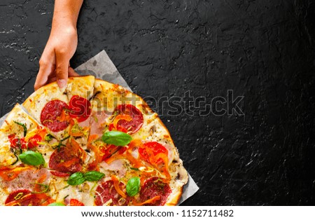 woman Hand takes a piece of Pizza with Mozzarella cheese, 