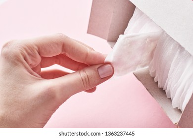 Woman Hand Takes Sanitary Pad Out Of The Box, Close Up