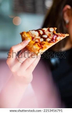 woman Hand takes a slice of chicken Pizza in cafe
