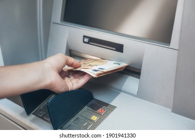 Woman hand taking money from bank cash ATM machine. Close up. Cash point. Finance, transactions, credit card, money withdraw, currency concept