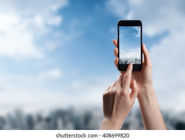 Woman Hand Taking Photo Of The City With A Smartphone