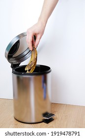 Woman Hand Throwing A Banana Peel Into The Garbage Bin