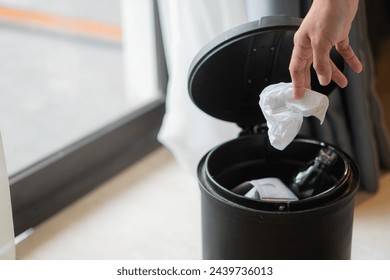 Woman hand throwing trash in garbage bin - Powered by Shutterstock