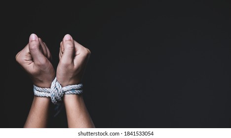 Woman Hand Tied Up With Rope, Depicting The Idea Of Freedom Of The Press Or Freedom Of Expression On Dark Background In Low Key. International Human Right Day Concept.